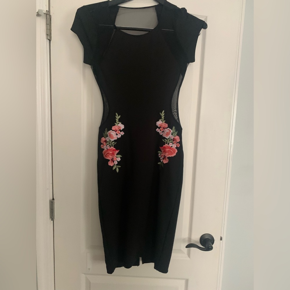Black dress with side sheer cutouts. Back top is sheer.